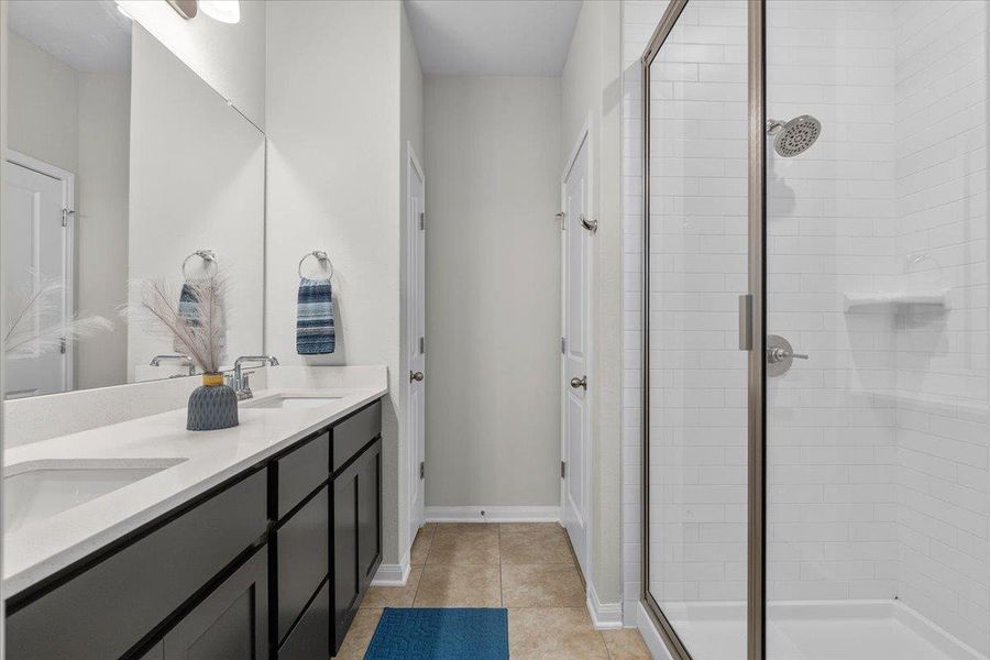 Clean lines and classic tiling define this functional bathroom with a dual vanity.