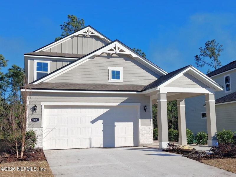 Front exterior of a new home in Seminole Palms, Palm Coast, FL, highlighting curb appeal (Image 19). Front exterior of a new home in Seminole Palms, Palm Coast, FL, highlighting curb appeal (Image 19).