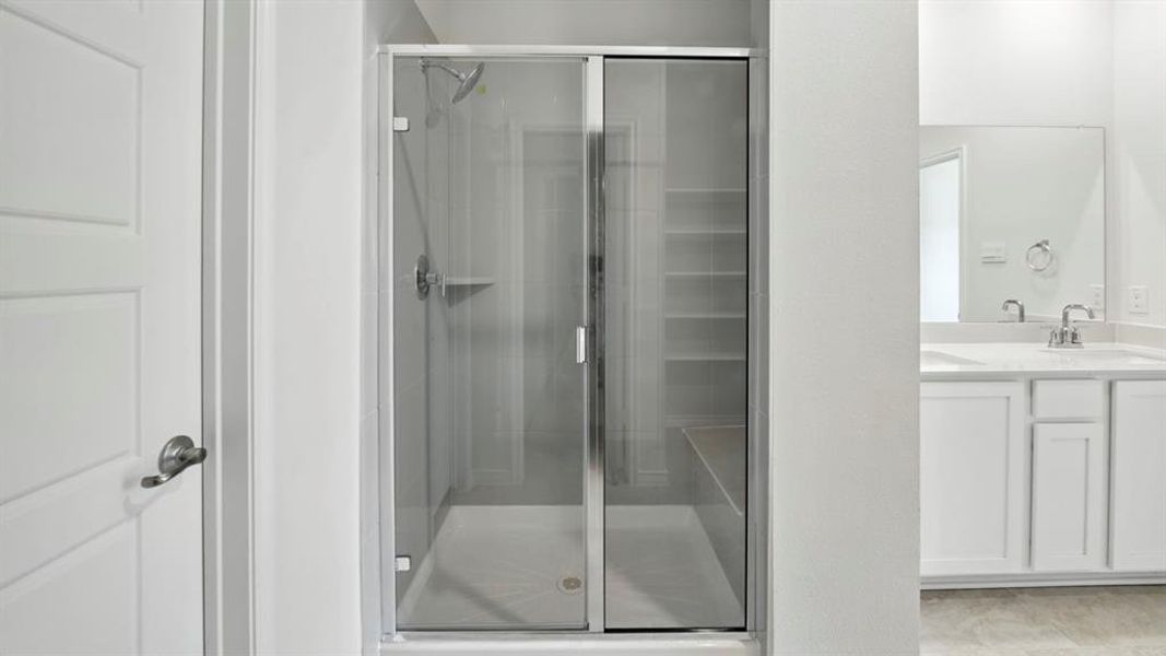 Bathroom featuring vanity and a shower stall Bathroom featuring vanity and a shower stall