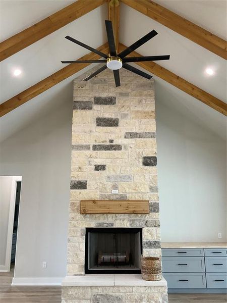 Floor to ceiling limestone wood burning with gas fireplace