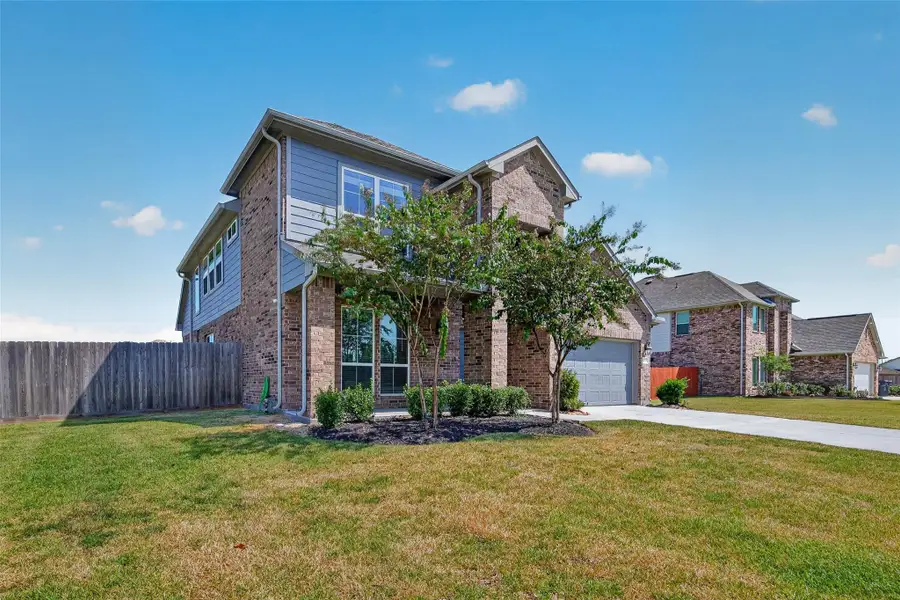 Front exterior of a new home in , Mont Belvieu, TX, highlighting curb appeal (Image 26).