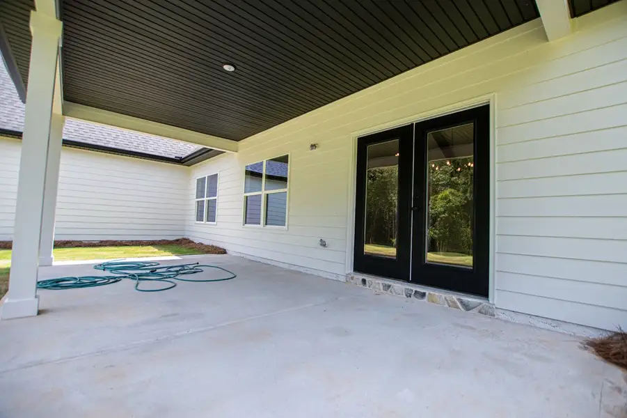 Exterior details and patio area of a home in WOODMONT RESERVE, Roopville (Image 49).