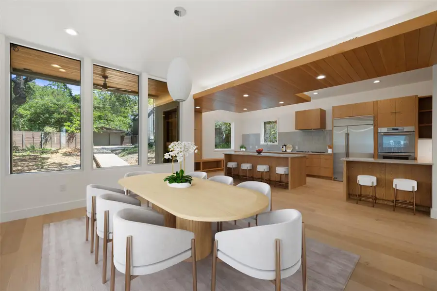Dining area with light wood finished floors and recessed lighting Dining area with light wood finished floors and recessed lighting