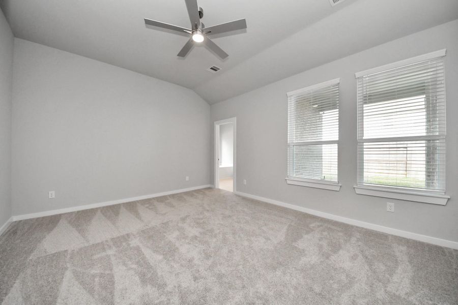 Another perspective unveils a comprehensive view of the serenity and comfort this primary suite offers.