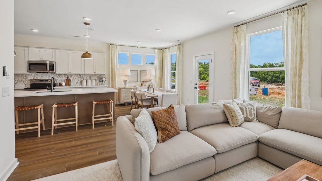 Gathering room with access to kitchen and dining area