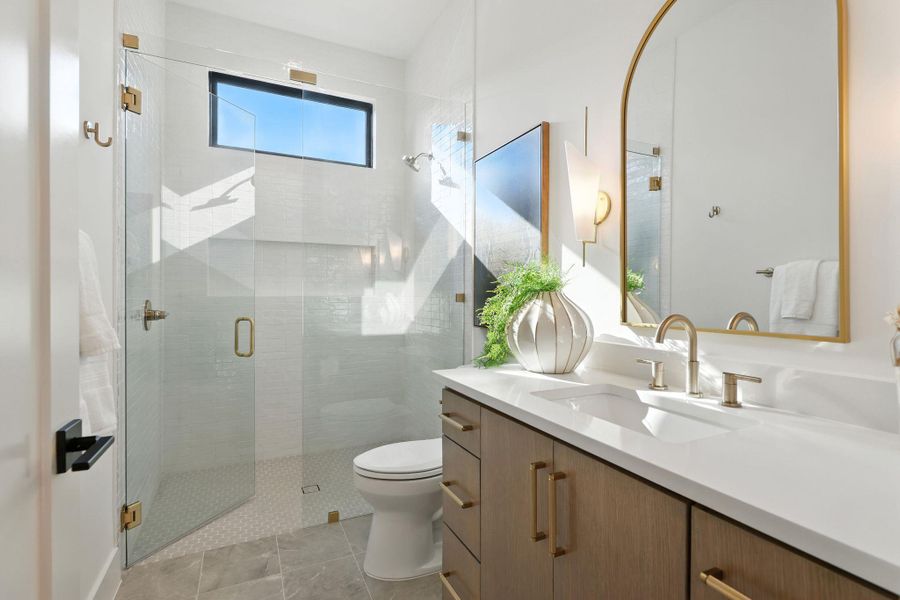Bathroom featuring vanity, a shower stall, and light tile patterned floors Bathroom featuring vanity, a shower stall, and light tile patterned floors
