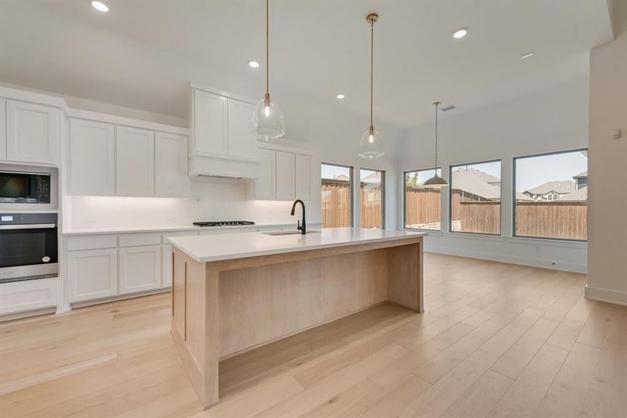 Kitchen featuring recessed lighting, oven, white cabinetry, decorative backsplash, and decorative light fixtures