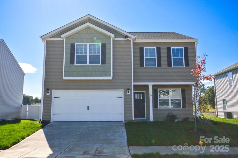 Front exterior of a new home in Tap Root Farms, Fletcher, NC, highlighting curb appeal (Image 1).