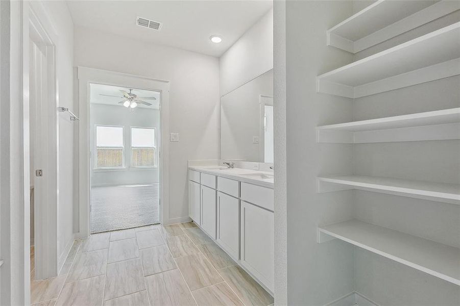 Bathroom featuring ceiling fan, tile patterned floors, and vanity