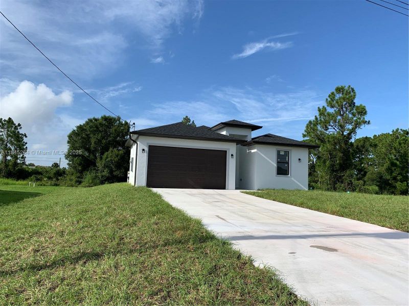 Front exterior of a new home in , Lehigh Acres, FL, highlighting curb appeal (Image 19).