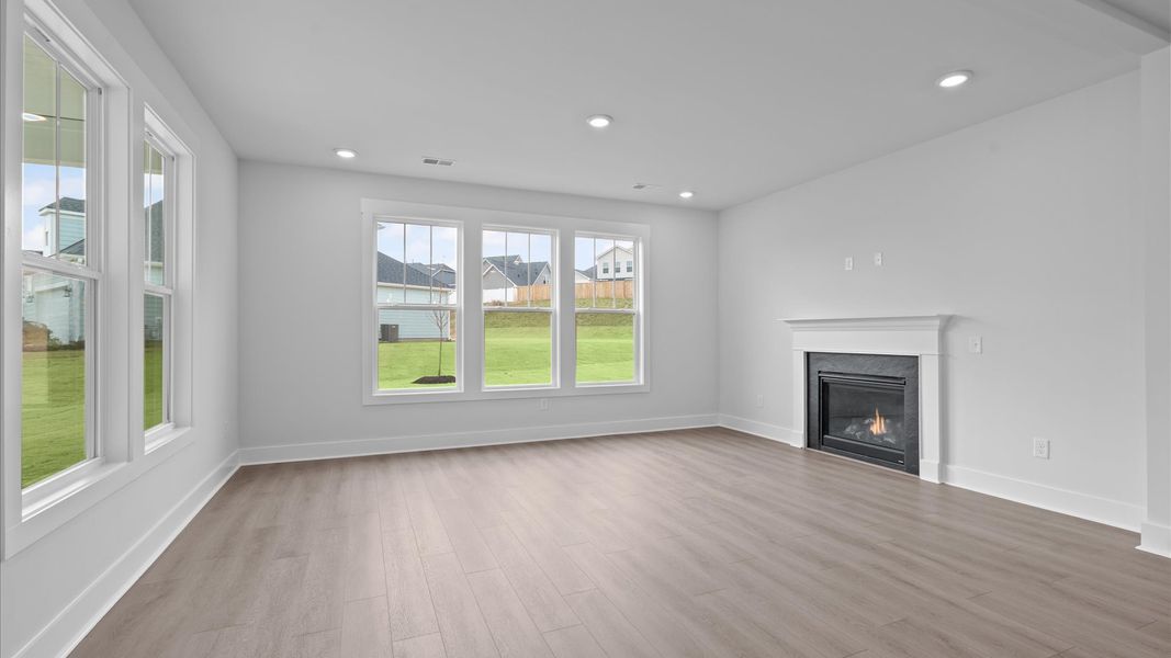 Hardwood flooring and high standards define this vibrant family room ideal for everyday living