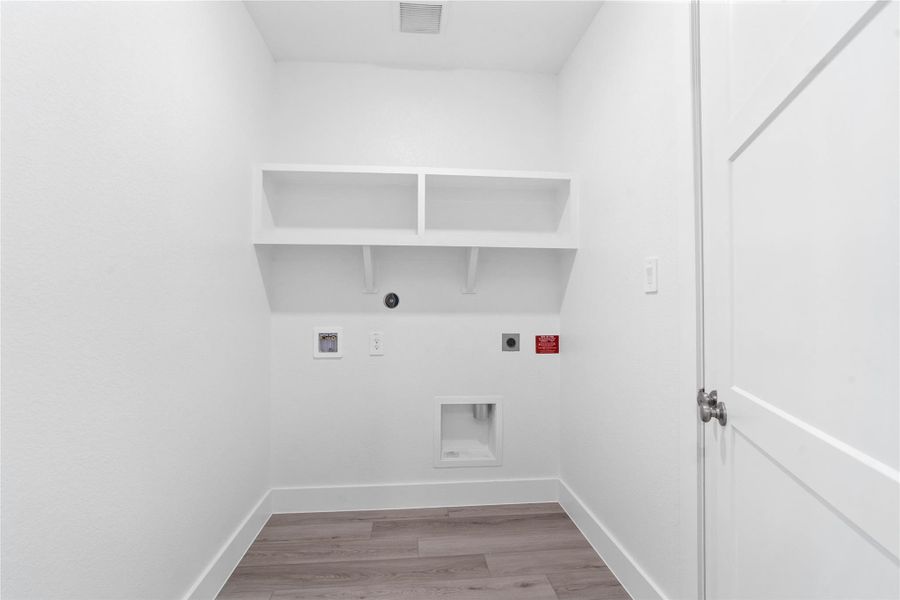 Maximize organization and efficiency in this dedicated laundry room, a clean and bright space designed to handle all your home's needs.