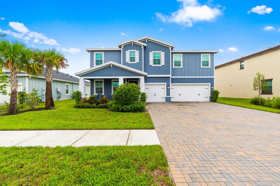 Front exterior of a new home in , Loxahatchee, FL, highlighting curb appeal (Image 2).