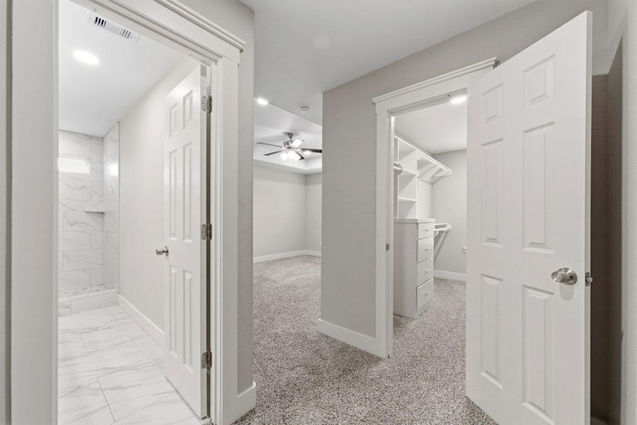 Spacious primary suite with direct access to the luxurious ensuite bath and expansive walk in closet.
