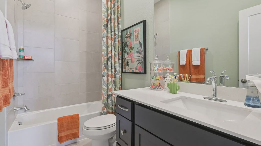 Representative furnished interior of a home built from the Adele by Chesmar Homes in Sunterra, Katy (Image 24).