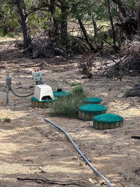 A well-maintained septic system is discreetly integrated into the natural, rugged landscape.