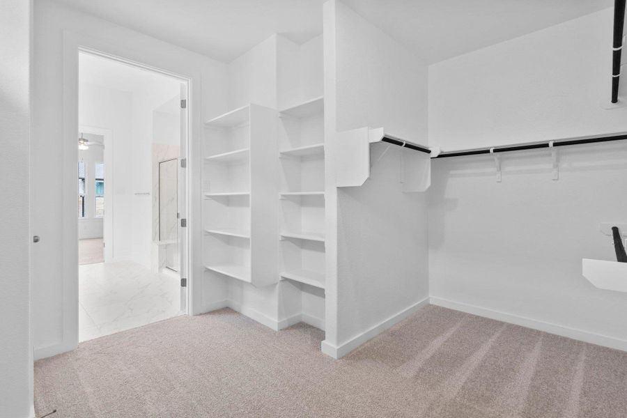 Walk-in closet in Primary Bedroom Walk-in closet in Primary Bedroom