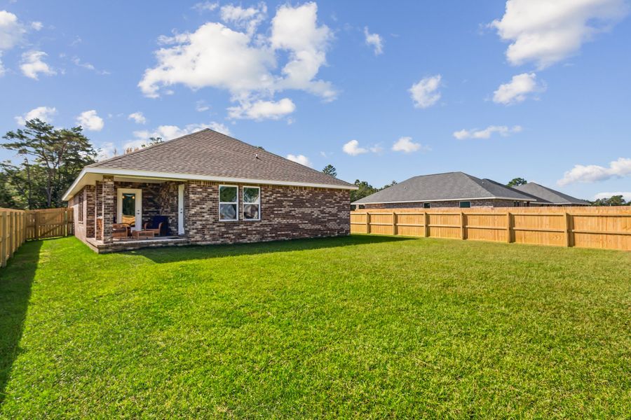 Representative exterior photo of a completed home built from the The Carlos by Herbst Homes in Doyle Hawkins Landing, Navarre, FL (Image 30).