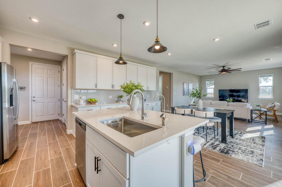 An open floorplan seamlessly connects this modern kitchen to the adjacent living spaces. An open floorplan seamlessly connects this modern kitchen to the adjacent living spaces.