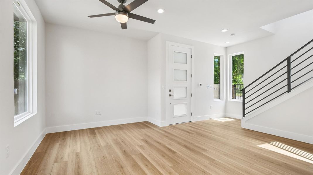Foyer with stairway, light wood-style floors, recessed lighting, and ceiling fan Foyer with stairway, light wood-style floors, recessed lighting, and ceiling fan
