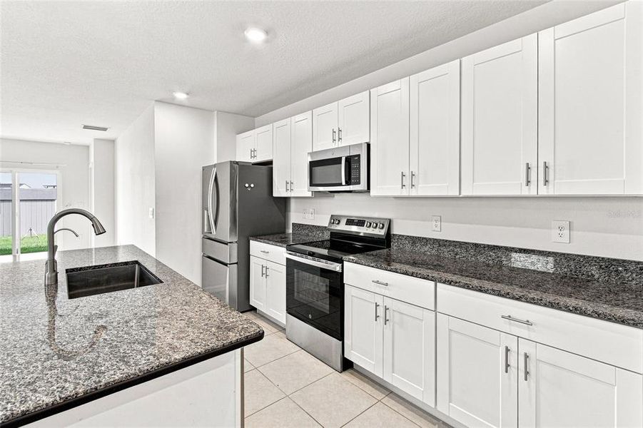 Furnished interior view inside a new home in The Isle of Avalon, Spring Hill (Image 6).