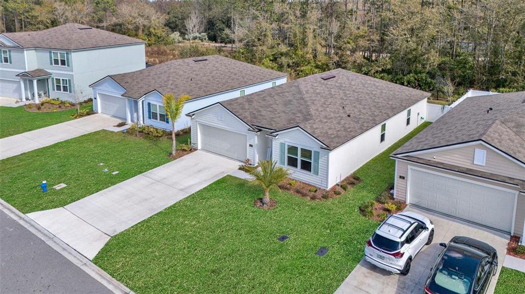 Front exterior of a new home in Sawmill Branch, Palm Coast, FL, highlighting curb appeal (Image 22).