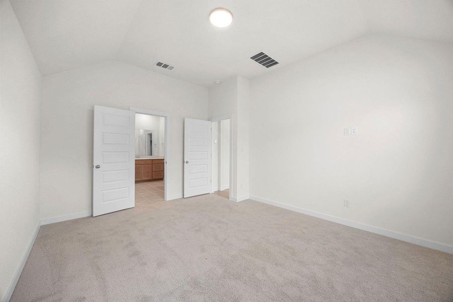 Primary Bedroom in the Sabine home plan by Trophy Signature Homes – REPRESENTATIVE PHOTO