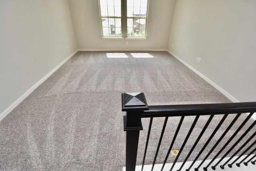 Carpeted spare room with baseboards Carpeted spare room with baseboards