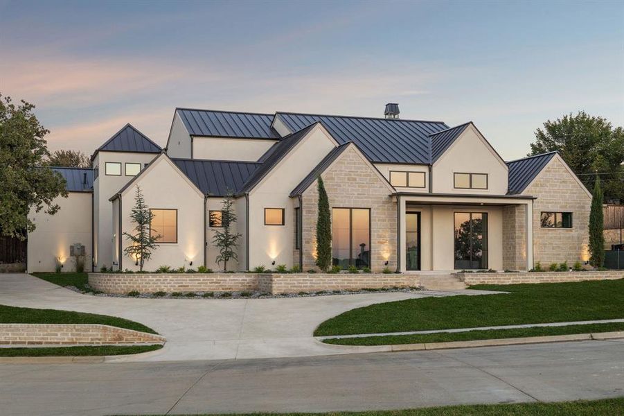 Modern inspired farmhouse with a standing seam roof, a metal roof, stucco siding, and a yard Modern inspired farmhouse with a standing seam roof, a metal roof, stucco siding, and a yard