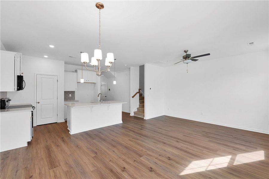 Bright and open-concept living space with hardwood