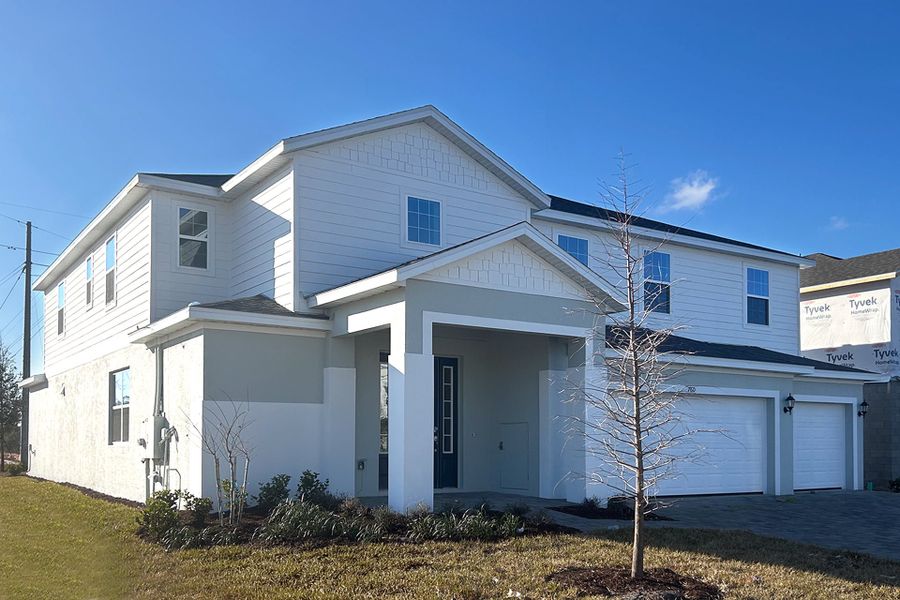 Front exterior of a new home in Trinity Gardens, Deland, FL, highlighting curb appeal (Image 6).