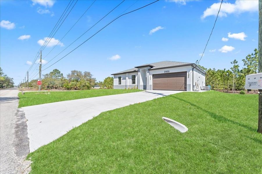 Front exterior of a new home in , Lehigh Acres, FL, highlighting curb appeal (Image 9).