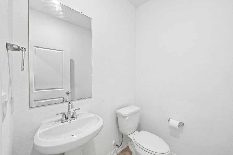 Clean lines and classic fixtures define this minimalist powder room.
