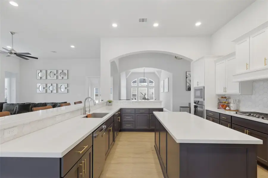 Another view of the expansive kitchen andoversized island at the heart of the home. Another view of the expansive kitchen andoversized island at the heart of the home.