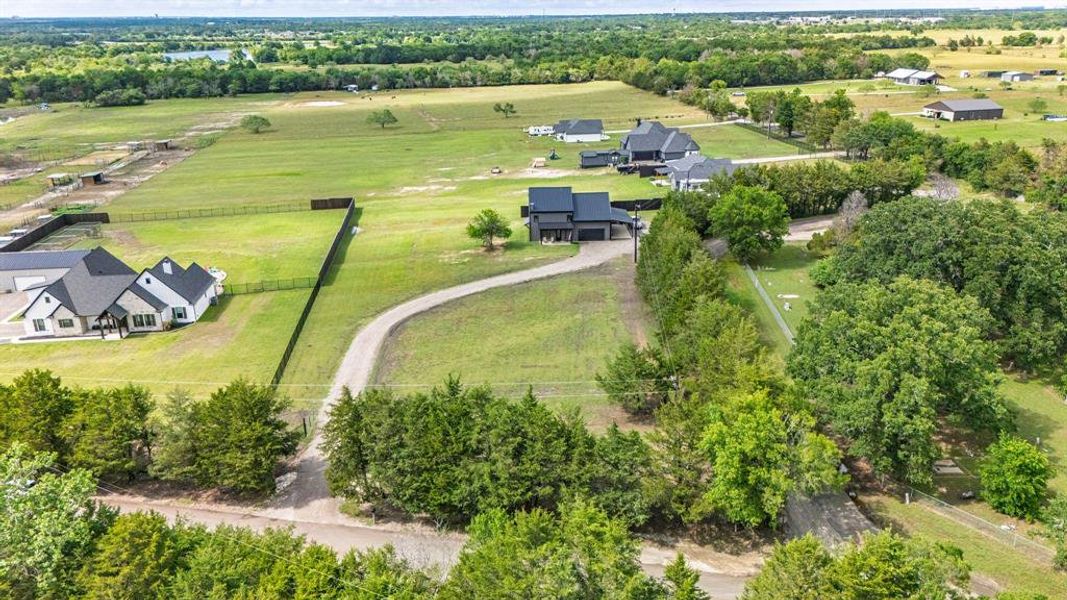 Aerial view of property's location with rural landscape, a tree filled landscape, and agricultural land Aerial view of property's location with rural landscape, a tree filled landscape, and agricultural land