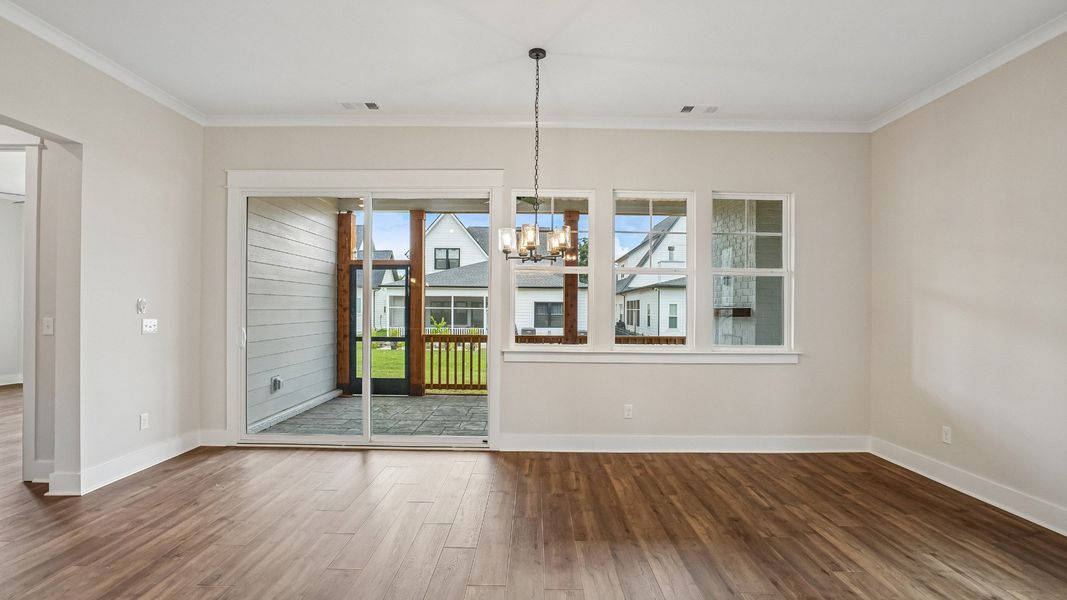 Dining area with light fixture and nearby screened-in outdoor living