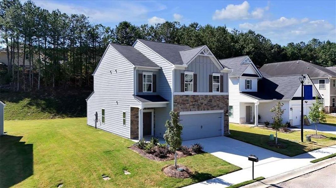 Front exterior of a new home in The View at Groover's Lake, Lithia Springs, GA, highlighting curb appeal (Image 2).