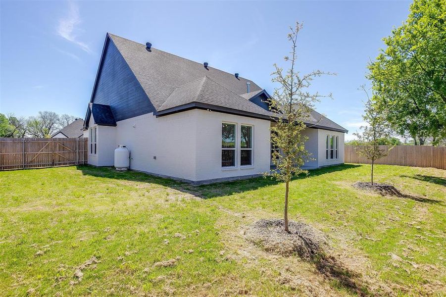 Back of house featuring a yard