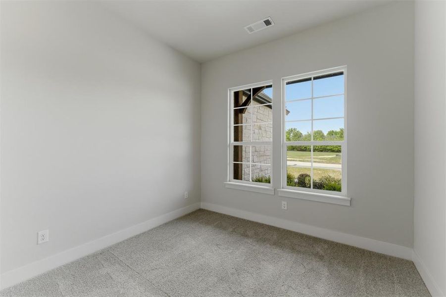 Empty room with light carpet and baseboards