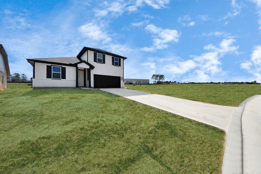 Actual exterior of home, construction - 90% complete. Glass front door, landscaping, and perimeter fence pending installation. Actual exterior of home, construction - 90% complete. Glass front door, landscaping, and perimeter fence pending installation.