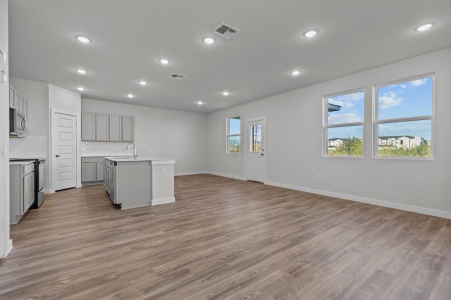 A kitchen with white cabinets.