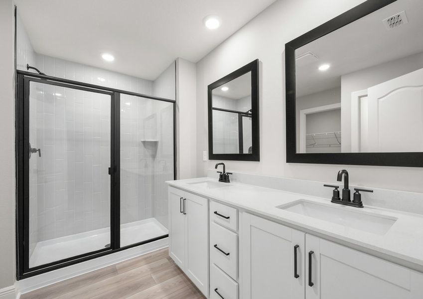 This master bathroom boasts this stunning dual-sink vanity and walk-in shower