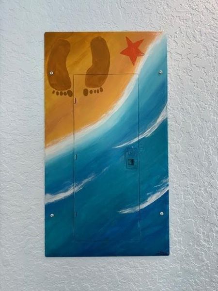 Attention to detail that they even had a local artist handpaint the breaker panel cover for inside the home.