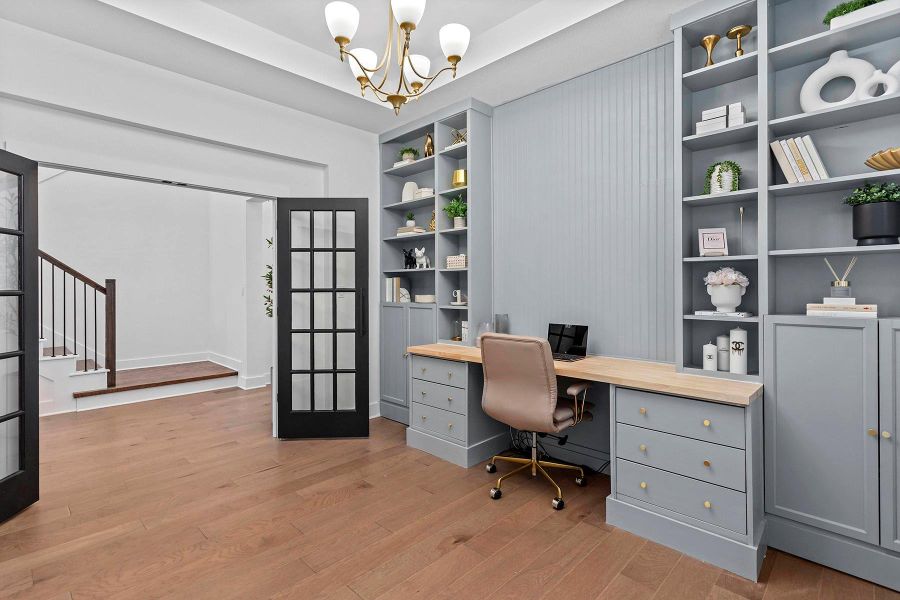 Office featuring french doors, a notable chandelier, and light wood-type flooring