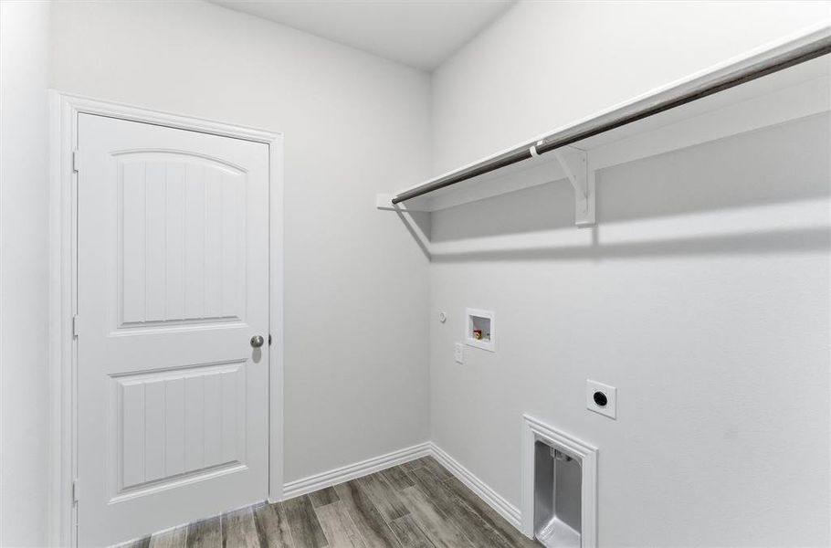 Laundry room with light wood-style flooring, electric dryer hookup, washer hookup, and hookup for a gas dryer Laundry room with light wood-style flooring, electric dryer hookup, washer hookup, and hookup for a gas dryer