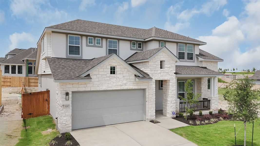 Front exterior of a new home in Lariat, Liberty Hill, TX, highlighting curb appeal (Image 2). Front exterior of a new home in Lariat, Liberty Hill, TX, highlighting curb appeal (Image 2).