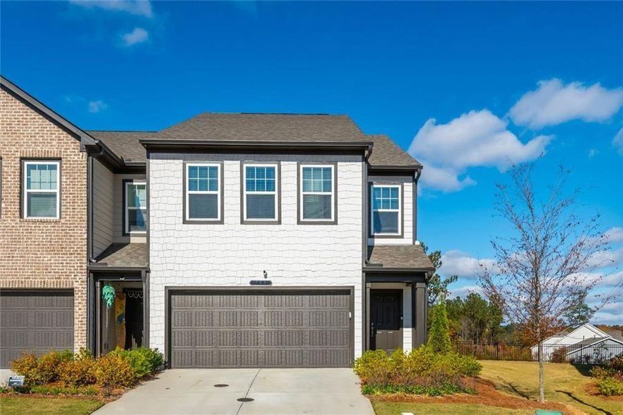 Front exterior of a new home in Avignon - Townhomes, Cumming, GA, highlighting curb appeal (Image 15). Front exterior of a new home in Avignon - Townhomes, Cumming, GA, highlighting curb appeal (Image 15).