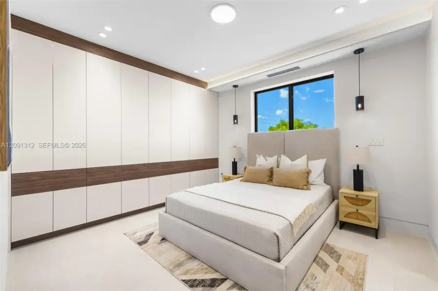 Floor-to-ceiling built-in cabinetry with integrated wood-finish detailing, recessed lighting, and wall-mounted pendant fixtures Floor-to-ceiling built-in cabinetry with integrated wood-finish detailing, recessed lighting, and wall-mounted pendant fixtures