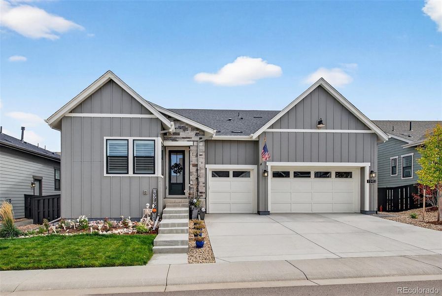Front Exterior (Daytime) – Clean architectural lines and contemporary finishes define this home’s curb appeal, featuring a three-car garage and thoughtfully landscaped front yard.
