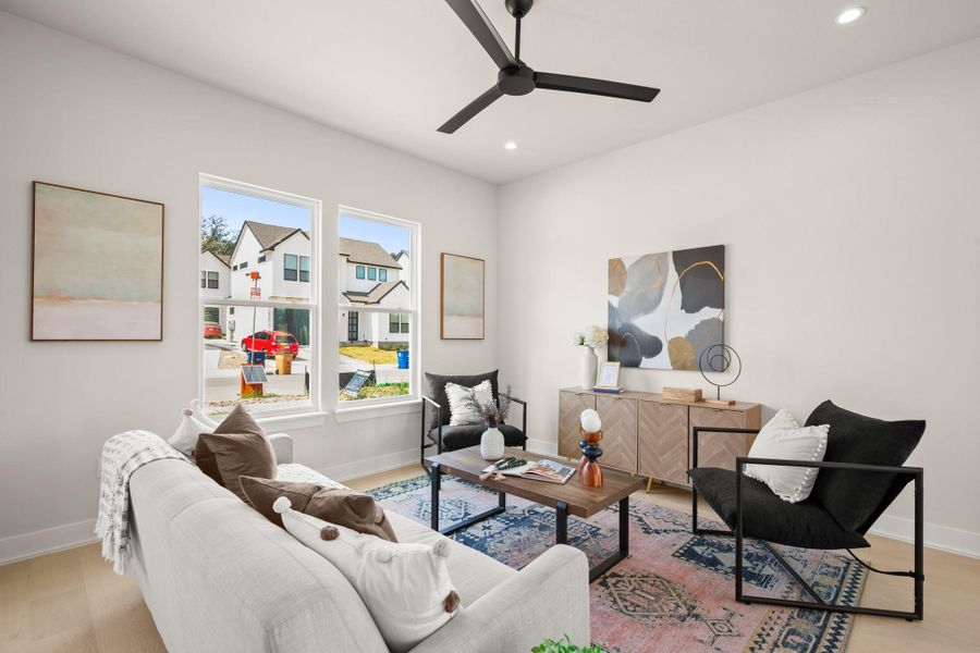 Living area featuring light wood finished floors, recessed lighting, and ceiling fan